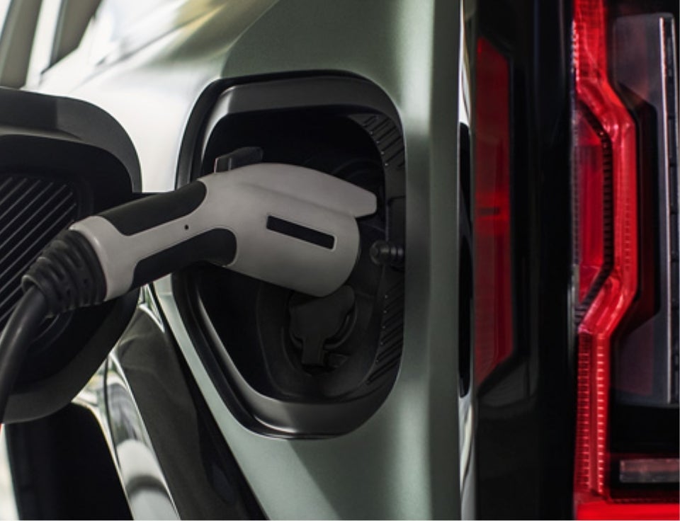 Close up of charging port with charger plugged in on a GMC Hummer EV SUV - Pointe GMC in Penns Grove NJ